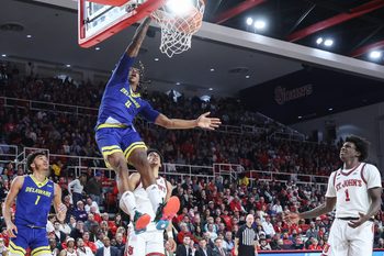 Dec 28, 2024; Queens, New York, USA;  Delaware Fightin Blue Hens guard Niels Lane (4) dunks in the first half against the St. John's Red Storm at Carnesecca Arena. Mandatory Credit: Wendell Cruz-Imagn Images