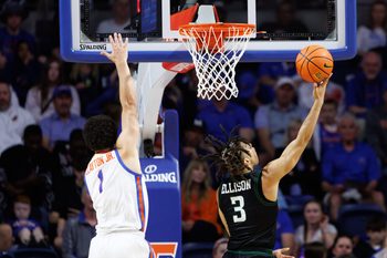 Dec 29, 2024; Gainesville, Florida, USA; Stetson Hatters guard Mehki Ellison (3) makes a layup over Florida Gators guard Walter Clayton Jr. (1) during the second half at Exactech Arena at the Stephen C. O'Connell Center. Mandatory Credit: Matt Pendleton-Imagn Images