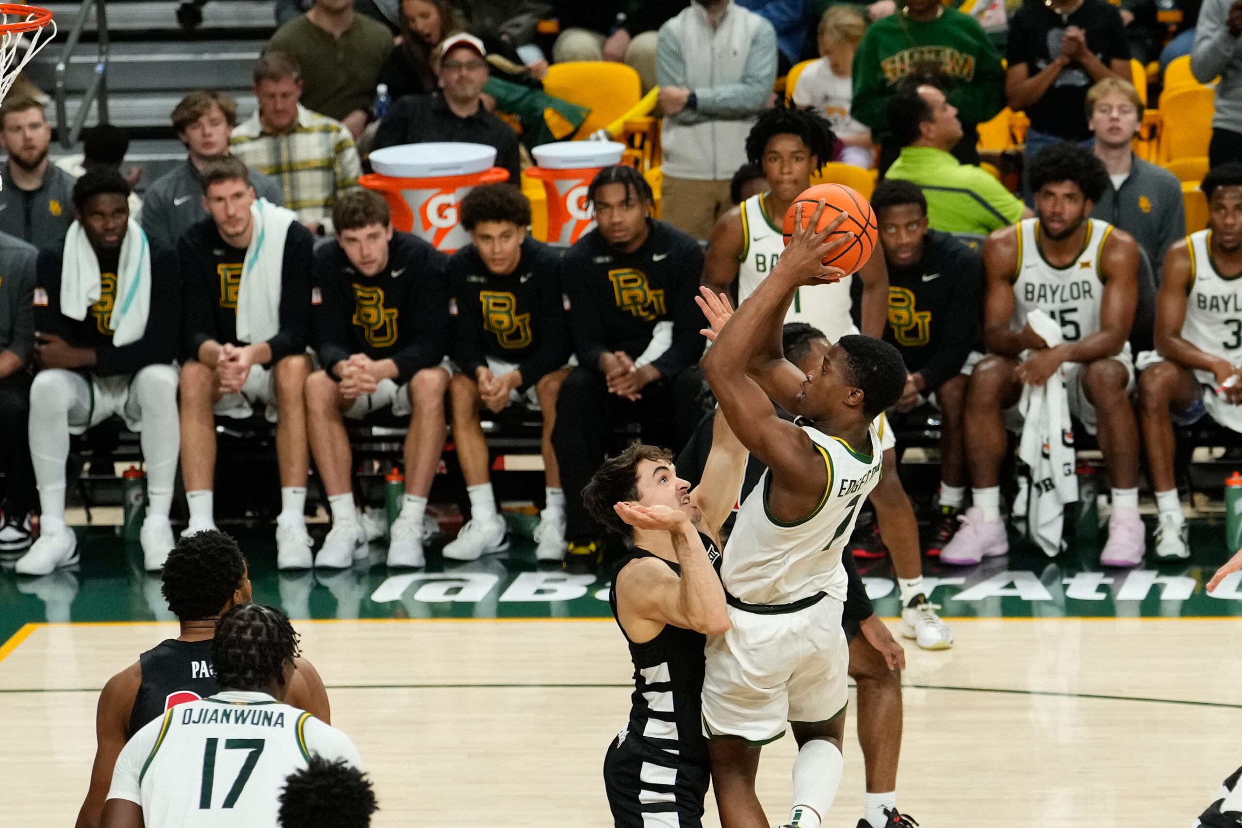 Jan 7, 2025; Waco, Texas, USA;  Baylor Bears guard VJ Edgecombe (7) scores a basket as he is fouled by Cincinnati Bearcats guard Connor Hickman (8) during the second half at Paul and Alejandra Foster Pavilion. Mandatory Credit: Chris Jones-Imagn Images