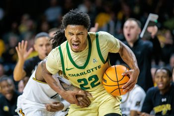 Jan 14, 2025; Wichita, Kansas, USA; Charlotte 49ers guard Jaehshon Thomas (22) drives to the basket during the first half against the Wichita State Shockers at Charles Koch Arena. Mandatory Credit: William Purnell-Imagn Images