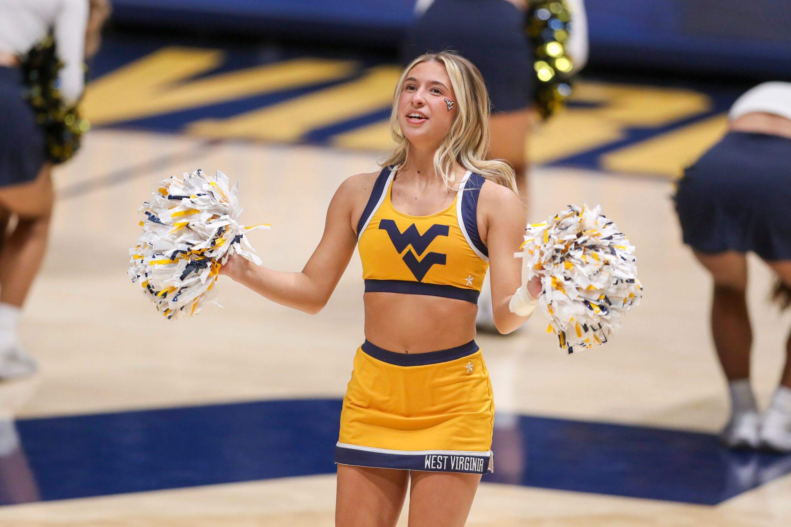 Jan 21, 2025; Morgantown, West Virginia, USA; A West Virginia Mountaineers cheerleader performs during the second half Arizona State Sun Devilsa at WVU Coliseum. Mandatory Credit: Ben Queen-Imagn Images