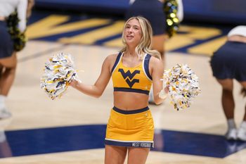 Jan 21, 2025; Morgantown, West Virginia, USA; A West Virginia Mountaineers cheerleader performs during the second half Arizona State Sun Devilsa at WVU Coliseum. Mandatory Credit: Ben Queen-Imagn Images