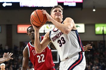 Feb 6, 2025; Spokane, Washington, USA; Gonzaga Bulldogs forward Ben Gregg (33) shoots against Loyola Marymount Lions center Rick Issanza (22) in the second half at McCarthey Athletic Center. Gonzaga Bulldogs won 73-53. Mandatory Credit: James Snook-Imagn Images