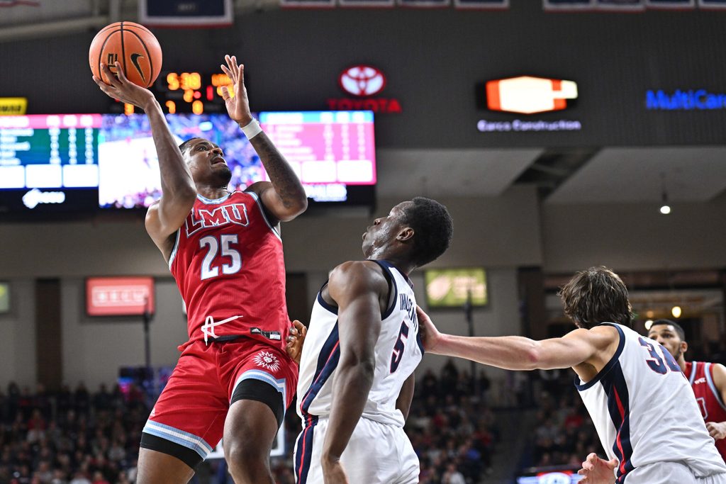Feb 6, 2025; Spokane, Washington, USA; Loyola Marymount Lions forward Caleb Stone-Carrawell (25) shoots against Gonzaga Bulldogs forward Emmanuel Innocenti (5) in the second half at McCarthey Athletic Center. Gonzaga Bulldogs won 73-53. Mandatory Credit: James Snook-Imagn Images