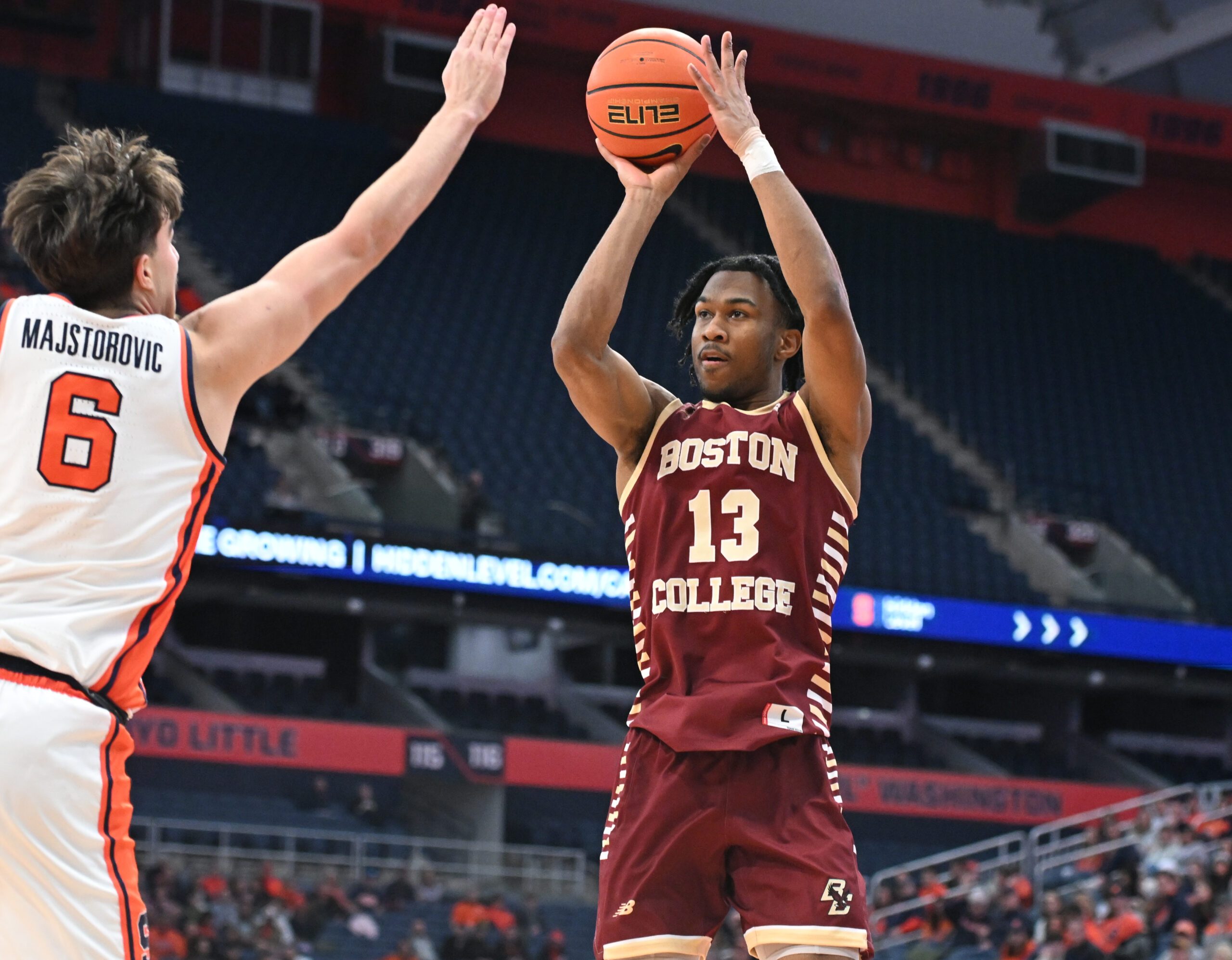 Feb 8, 2025; Syracuse, New York, USA; Boston College Eagles guard Donald Hand Jr. (13) takes a jump shot as Syracuse Orange forward Petar Majstorovic (6) defends in the first half at the JMA Wireless Dome. Mandatory Credit: Mark Konezny-Imagn Images