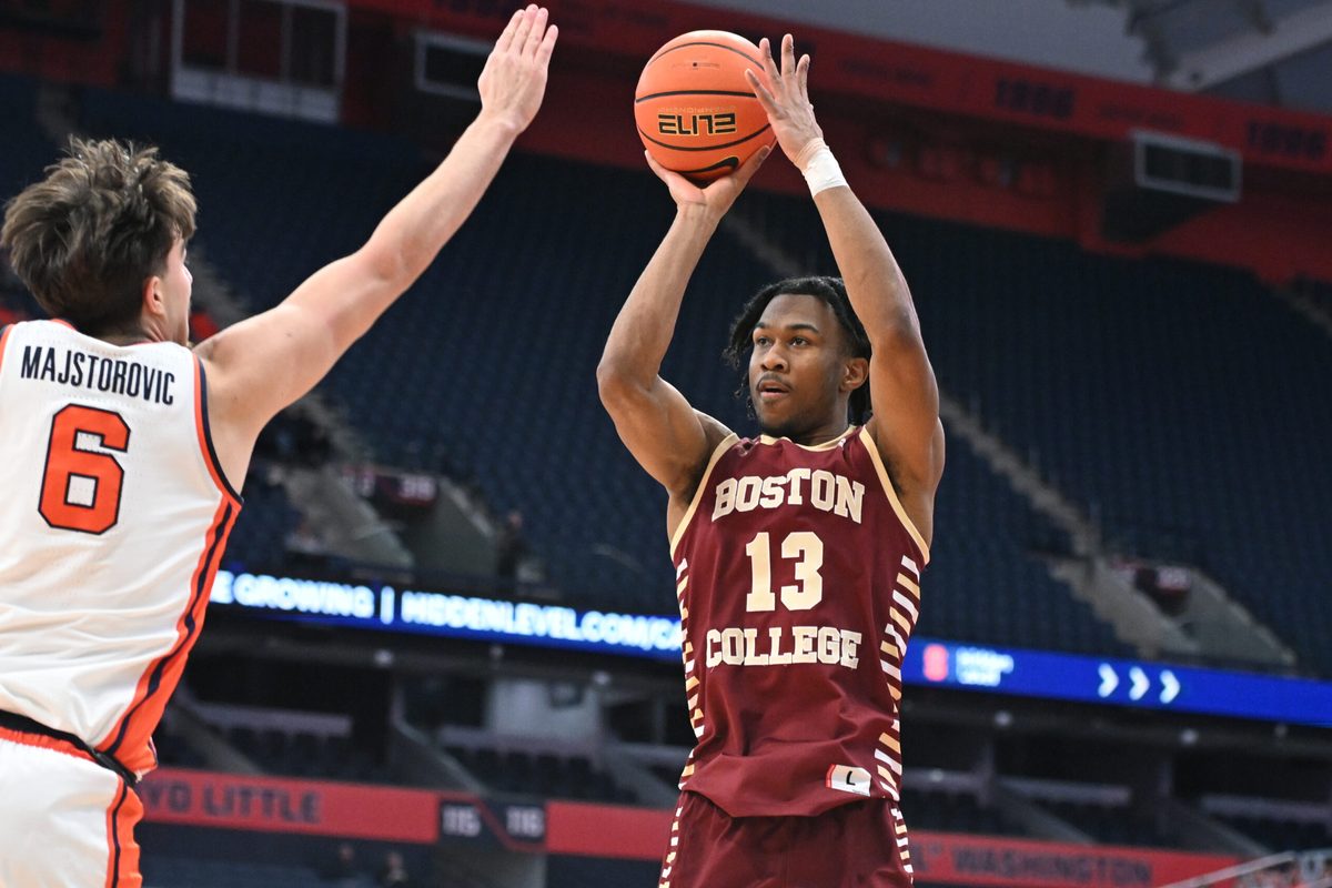 Feb 8, 2025; Syracuse, New York, USA; Boston College Eagles guard Donald Hand Jr. (13) takes a jump shot as Syracuse Orange forward Petar Majstorovic (6) defends in the first half at the JMA Wireless Dome. Mandatory Credit: Mark Konezny-Imagn Images