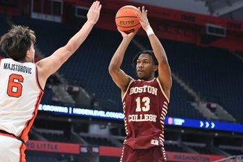 Feb 8, 2025; Syracuse, New York, USA; Boston College Eagles guard Donald Hand Jr. (13) takes a jump shot as Syracuse Orange forward Petar Majstorovic (6) defends in the first half at the JMA Wireless Dome. Mandatory Credit: Mark Konezny-Imagn Images