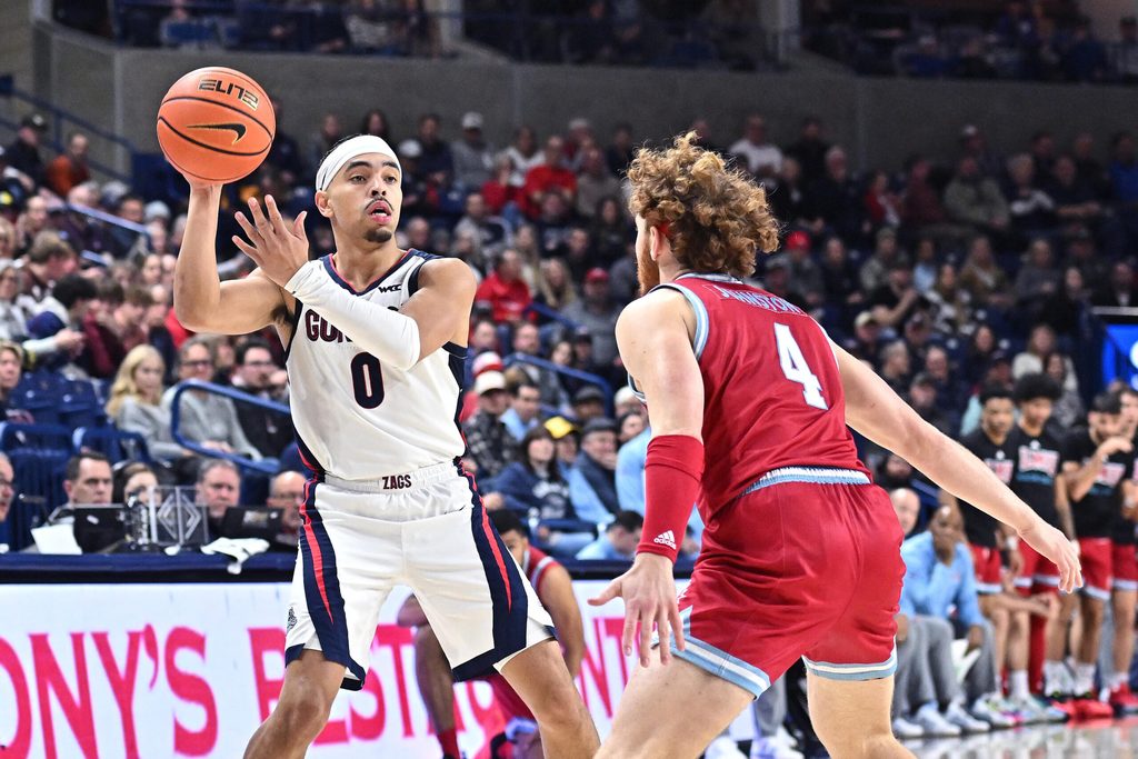 Feb 6, 2025; Spokane, Washington, USA; Gonzaga Bulldogs guard Ryan Nembhard (0) passes the ball against Loyola Marymount Lions guard Will Johnston (4) in the second half at McCarthey Athletic Center. Mandatory Credit: James Snook-Imagn Images