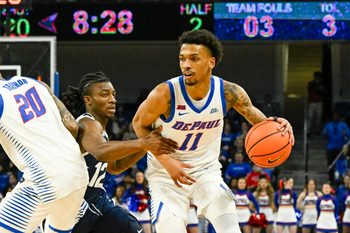 Feb 22, 2025; Chicago, Illinois, USA;  DePaul Blue Demons guard CJ Gunn (11) moves the ball against Butler Bulldogs guard Kolby King (12) during the second half at Wintrust Arena. Mandatory Credit: Matt Marton-Imagn Images