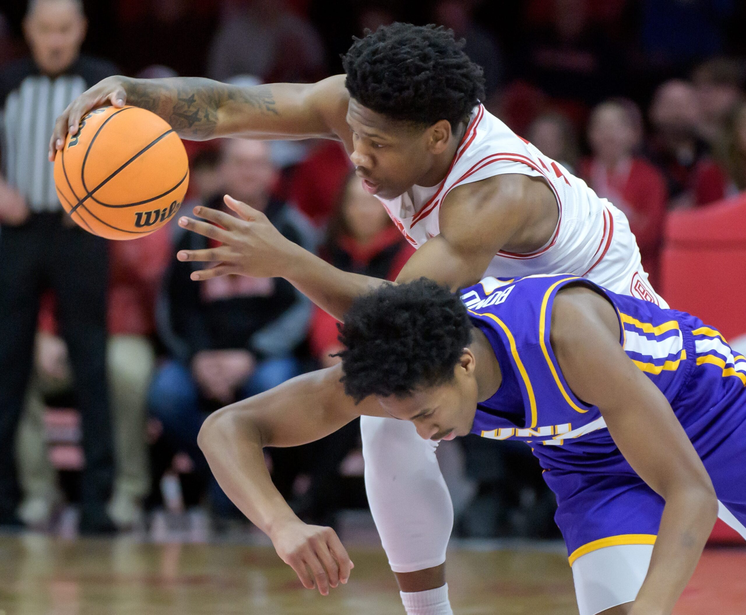 Bradley's Jaquan Johnson, top, steals the ball from Northern Iowa's Leon Bond III in the first half of their Missouri Valley Conference basketball game Sunday, March 2, 2025 at Carver Arena in Peoria. The Braves won the season finale 73-56.