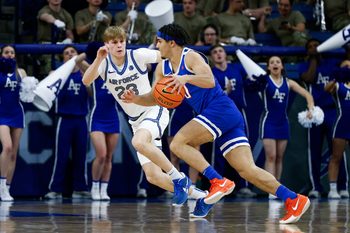 Mar 4, 2025; Colorado Springs, Colorado, USA; Boise State Broncos guard Julian Bowie (0) controls the ball as Air Force Falcons guard Sam Duskin (23) guards in the second half at Clune Arena. Mandatory Credit: Isaiah J. Downing-Imagn Images