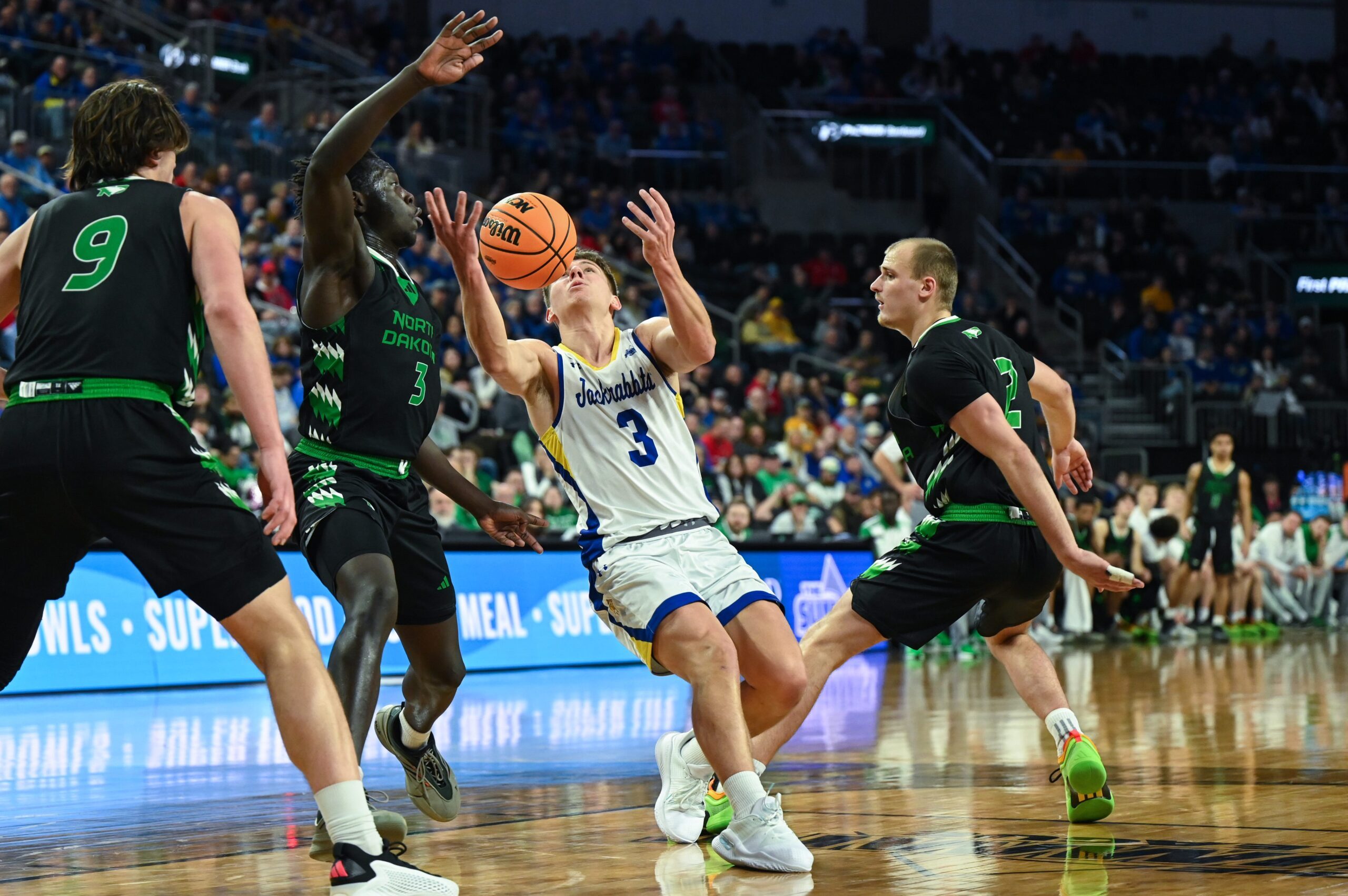 South Dakota State Jackrabbits guard Joe Sayler (3) fumbles the ball for a brief moment on Friday, March 7, 2025, at Denny Sanford Premier Center in Sioux Falls, S.D.