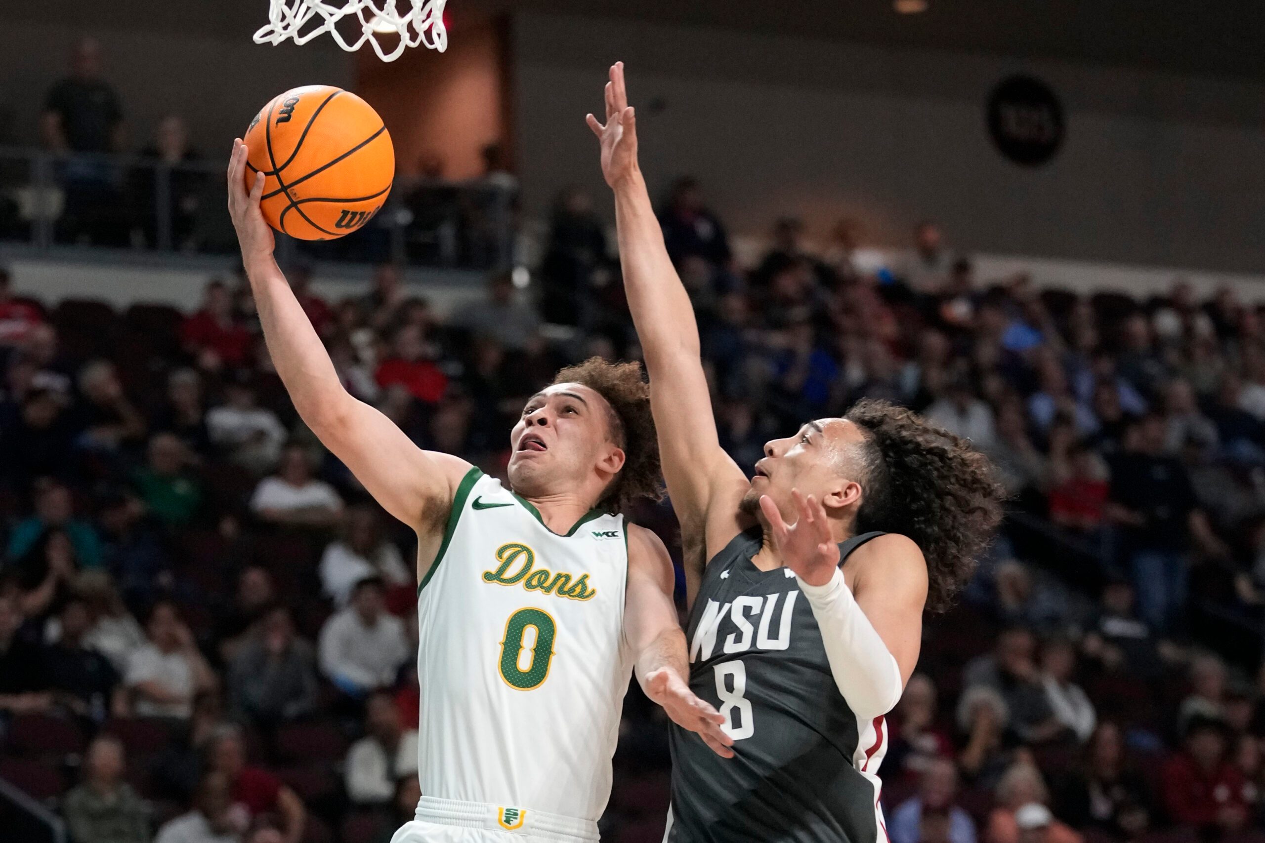 March 9, 2025; Las Vegas, NV, USA; San Francisco Dons guard Ryan Beasley (0) shoots the basketball against Washington State Cougars guard Nate Calmese (8) during the second half in the quarterfinal of the West Coast Conference tournament at Orleans Arena. Mandatory Credit: Kyle Terada-Imagn Images