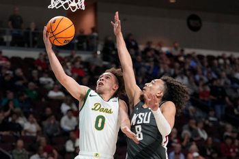 March 9, 2025; Las Vegas, NV, USA; San Francisco Dons guard Ryan Beasley (0) shoots the basketball against Washington State Cougars guard Nate Calmese (8) during the second half in the quarterfinal of the West Coast Conference tournament at Orleans Arena. Mandatory Credit: Kyle Terada-Imagn Images