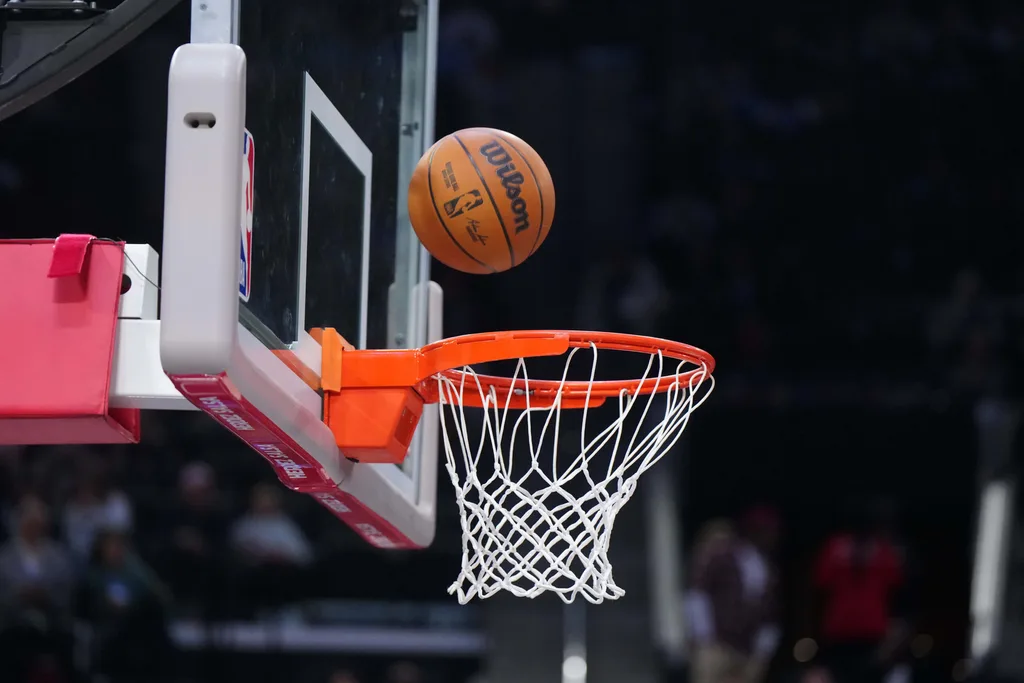 Mar 9, 2025; Inglewood, California, USA; An official Wilson NBA basketball approaches the rim and net at the Intuit Dome. Mandatory Credit: Kirby Lee-Imagn Images