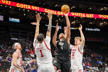 Mar 11, 2025; Kansas City, MO, USA; UCF Knights guard Keyshawn Hall (4) shoots the ball over Utah Utes guard Miro Little (1) during the second half at T-Mobile Center. Mandatory Credit: William Purnell-Imagn Images