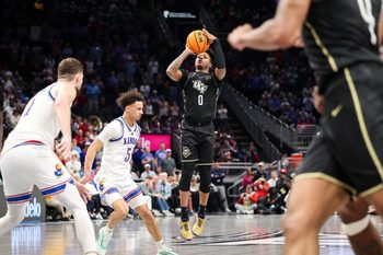 Mar 12, 2025; Kansas City, MO, USA; UCF Knights guard Jordan Ivy-Curry (0) shoots the ball during the second half against the Kansas Jayhawks at T-Mobile Center. Mandatory Credit: William Purnell-Imagn Images
