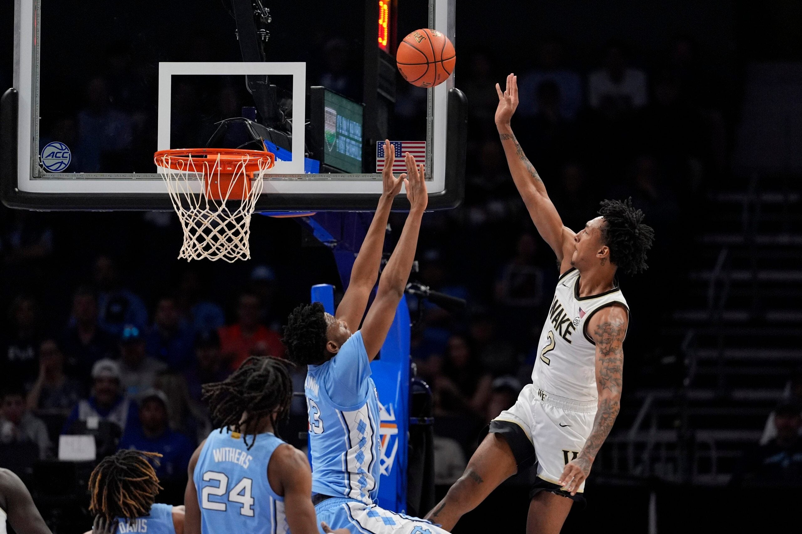 Mar 13, 2025; Charlotte, NC, USA; Wake Forest Demon Deacons guard Juke Harris (2) shoots a jumper over North Carolina Tar Heels forward Jalen Washington (13) during the first half at Spectrum Center. Mandatory Credit: Jim Dedmon-Imagn Images