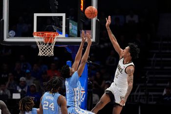 Mar 13, 2025; Charlotte, NC, USA; Wake Forest Demon Deacons guard Juke Harris (2) shoots a jumper over North Carolina Tar Heels forward Jalen Washington (13) during the first half at Spectrum Center. Mandatory Credit: Jim Dedmon-Imagn Images