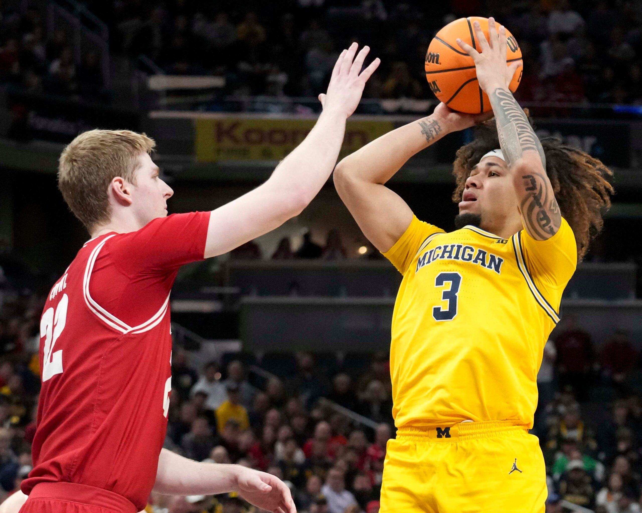 Wisconsin Badgers forward Steven Crowl (22) guards Michigan Wolverines guard Tre Donaldson (3) as he shoots the ball during the second half of the 2025 TIAA Big Ten Men’s Basketball Tournament final game on Sunday, March 16, 2025, at Gainbridge Fieldhouse in Indianapolis. Michigan defeated Wisconsin 59-53.