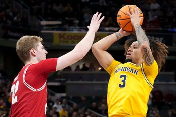 Wisconsin Badgers forward Steven Crowl (22) guards Michigan Wolverines guard Tre Donaldson (3) as he shoots the ball during the second half of the 2025 TIAA Big Ten Men’s Basketball Tournament final game on Sunday, March 16, 2025, at Gainbridge Fieldhouse in Indianapolis. Michigan defeated Wisconsin 59-53.