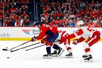 Mar 18, 2025; Washington, District of Columbia, USA; Washington Capitals center Connor McMichael (24) moves the puck against Detroit Red Wings defenseman Moritz Seider (53) during the first period at Capital One Arena. Mandatory Credit: Peter Casey-Imagn Images