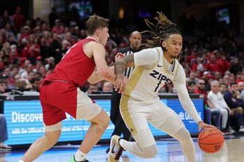 Akron Zips guard Shammah Scott (1) drives to the basket around Miami Redhawks guard Evan Ipsaro (2) during the Mid-American Conference Tournament championship game March 15, 2025, in Cleveland, Ohio.