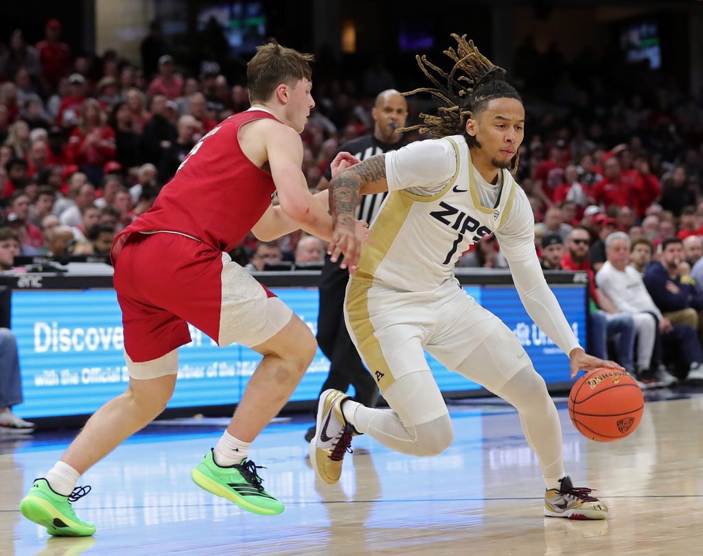 Akron Zips guard Shammah Scott (1) drives to the basket around Miami Redhawks guard Evan Ipsaro (2) during the Mid-American Conference Tournament championship game March 15, 2025, in Cleveland, Ohio.