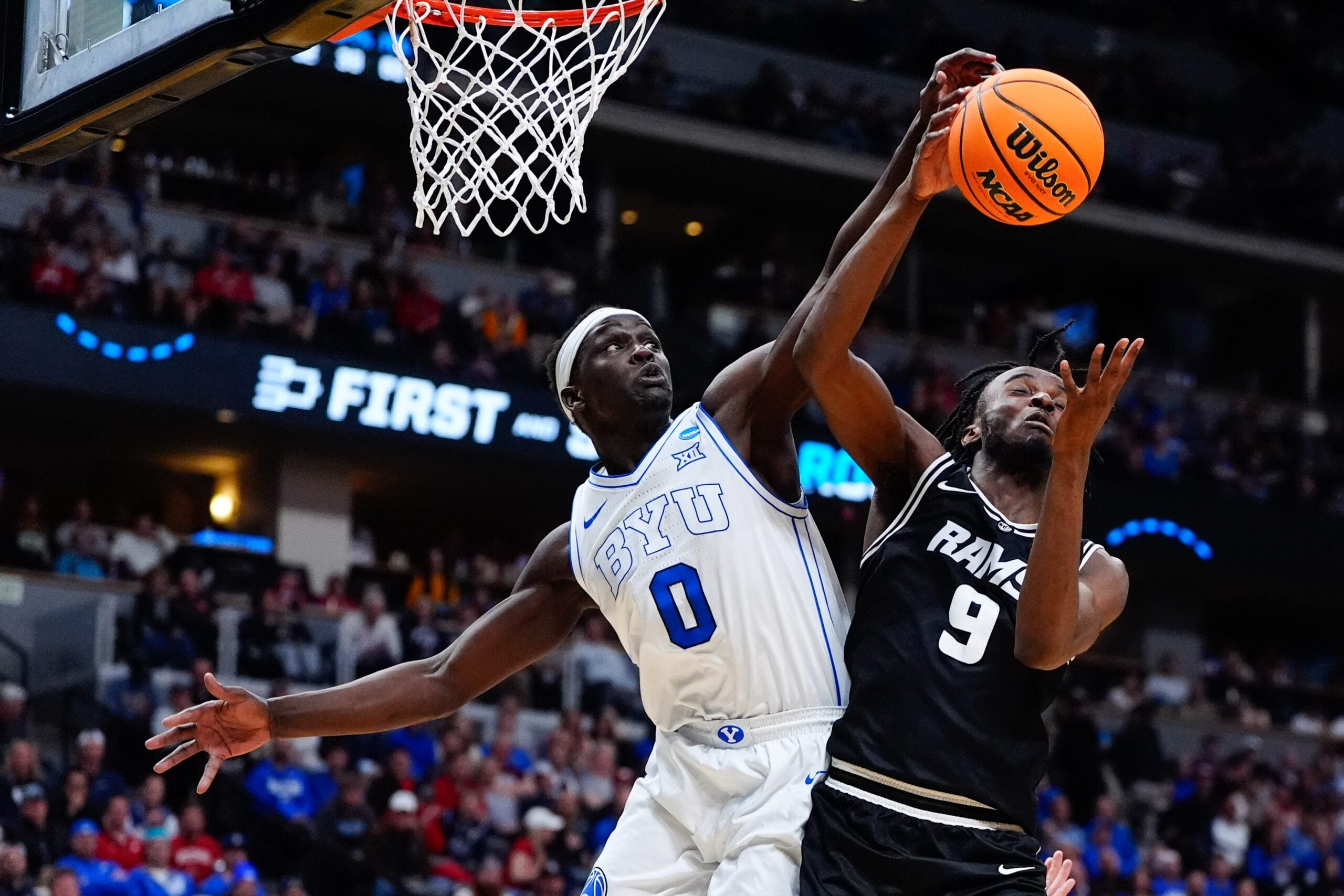 Mar 20, 2025; Denver, CO, USA; Brigham Young Cougars forward Mawot Mag (0) and VCU Rams forward Luke Bamgboye (9) go after a rebound during the second half in the first round of the NCAA Tournament at Ball Arena. Mandatory Credit: Ron Chenoy-Imagn Images