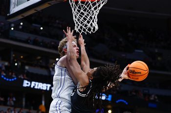 Mar 20, 2025; Denver, CO, USA; Brigham Young Cougars forward Richie Saunders (15) passes the ball away from VCU Rams guard Brandon Jennings (0) during the second half in the first round of the NCAA Tournament at Ball Arena. Mandatory Credit: Isaiah J. Downing-Imagn Images