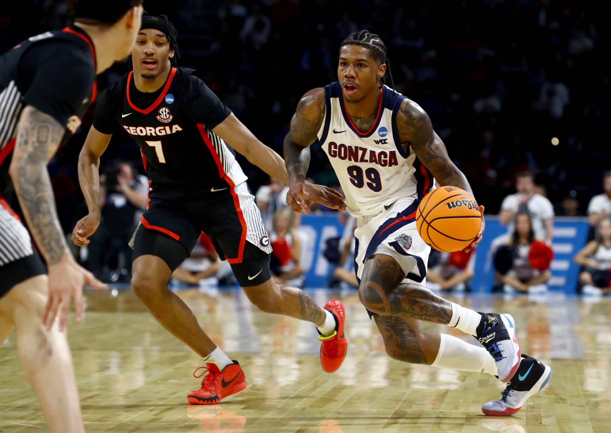 Mar 20, 2025; Wichita, KS, USA; Gonzaga Bulldogs guard Khalif Battle (99) dribbles against Georgia Bulldogs guard Tyrin Lawrence (7) in the second half of a first round men’s NCAA Tournament game at Intrust Bank Arena. Mandatory Credit: Nick Tre. Smith-Imagn Images