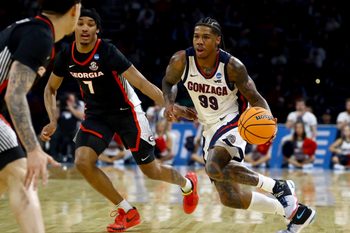 Mar 20, 2025; Wichita, KS, USA; Gonzaga Bulldogs guard Khalif Battle (99) dribbles against Georgia Bulldogs guard Tyrin Lawrence (7) in the second half of a first round men’s NCAA Tournament game at Intrust Bank Arena. Mandatory Credit: Nick Tre. Smith-Imagn Images