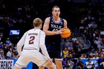 March 20, 2025; Denver, CO, USA; Yale Bulldogs forward Nick Townsend (42) looks to pass the ball as Texas A&M Aggies guard Hayden Hefner (2) defends during the second half at Ball Arena. Mandatory Credit: Isaiah J. Downing-Imagn Images