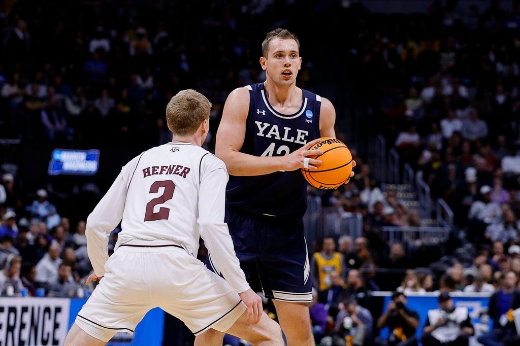 March 20, 2025; Denver, CO, USA; Yale Bulldogs forward Nick Townsend (42) looks to pass the ball as Texas A&M Aggies guard Hayden Hefner (2) defends during the second half at Ball Arena. Mandatory Credit: Isaiah J. Downing-Imagn Images