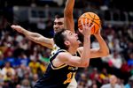 March 20, 2025; Denver, CO, USA; UC San Diego Tritons guard Tyler McGhie (13) attempts to shoot the ball as Michigan Wolverines center Vladislav Goldin (50) defends during the second half at Ball Arena. Mandatory Credit: Ron Chenoy-Imagn Images