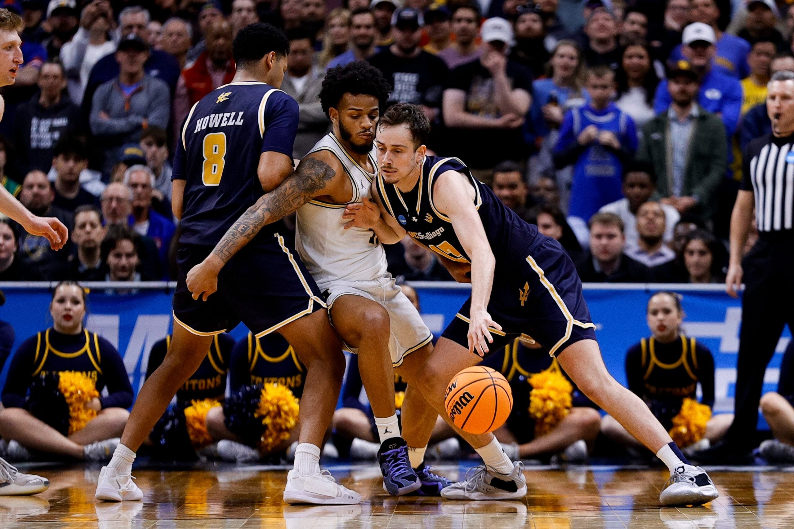 March 20, 2025; Denver, CO, USA; UC San Diego Tritons guard Tyler McGhie (13) dribbles the ball as guard Chris Howell (8) screens and Michigan Wolverines guard Roddy Gayle Jr. (11) defends during the second half at Ball Arena. Mandatory Credit: Isaiah J. Downing-Imagn Images