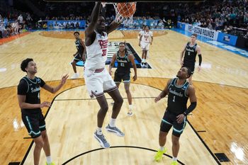 Mar 20, 2025; Wichita, KS, USA; Texas Tech Red Raiders forward Federiko Federiko (33) dunks against North Carolina-Wilmington Seahawks guard Nolan Hodge (4) and guard Donovan Newby (1) in the second half of a first round men’s NCAA Tournament game at Intrust Bank Arena. Mandatory Credit: Kirby Lee-Imagn Images