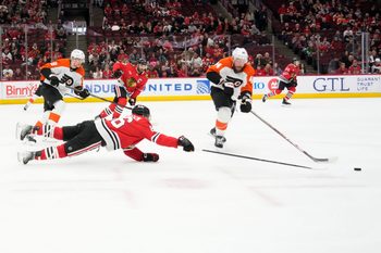 Mar 23, 2025; Chicago, Illinois, USA; Chicago Blackhawks center Teuvo Teravainen (86) and Philadelphia Flyers left wing Nicolas Deslauriers (44) go for the puck during the third period at United Center. Mandatory Credit: David Banks-Imagn Images