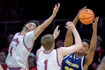 Chattanooga's Latif Diouf, right, pulls in a rebound over Bradley's Corey Thomas, left, and Almar Atlason in the second half of their NIT quarterfinal basketball game Tuesday, March 25, 2025 at Carver Arena in Peoria. The Mocs advanced to the semifinals with a 67-65 win.