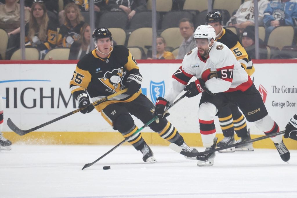 Mar 30, 2025; Pittsburgh, Pennsylvania, USA; Ottawa Senators left wing David Perron (57) moves the puck against Pittsburgh Penguins center Noel Acciari (55) during the first period at PPG Paints Arena. Mandatory Credit: Charles LeClaire-Imagn Images
