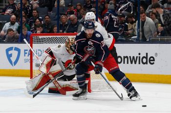 Apr 8, 2025; Columbus, Ohio, USA; Columbus Blue Jackets center Boone Jenner (38) passes the puck as Ottawa Senators left wing Claude Giroux (28) defends during the first period at Nationwide Arena. Mandatory Credit: Russell LaBounty-Imagn Images