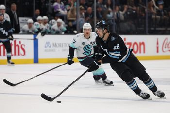 Apr 8, 2025; Salt Lake City, Utah, USA; Utah Hockey Club center Jack McBain (22) skates with the puck against the Seattle Kraken during the third period at Delta Center. Mandatory Credit: Rob Gray-Imagn Images