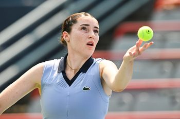 Jul 26, 2025; Montreal, QC, Canada; Elsa Jacquemot (FRA) serves the ball to Carol Zhao (CAN) (not pictured) in qualifying play at IGA Stadium. Mandatory Credit: David Kirouac-Imagn Images