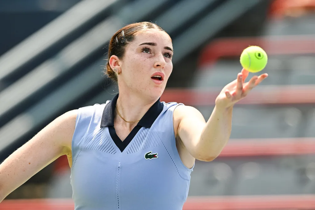 Jul 26, 2025; Montreal, QC, Canada; Elsa Jacquemot (FRA) serves the ball to Carol Zhao (CAN) (not pictured) in qualifying play at IGA Stadium. Mandatory Credit: David Kirouac-Imagn Images