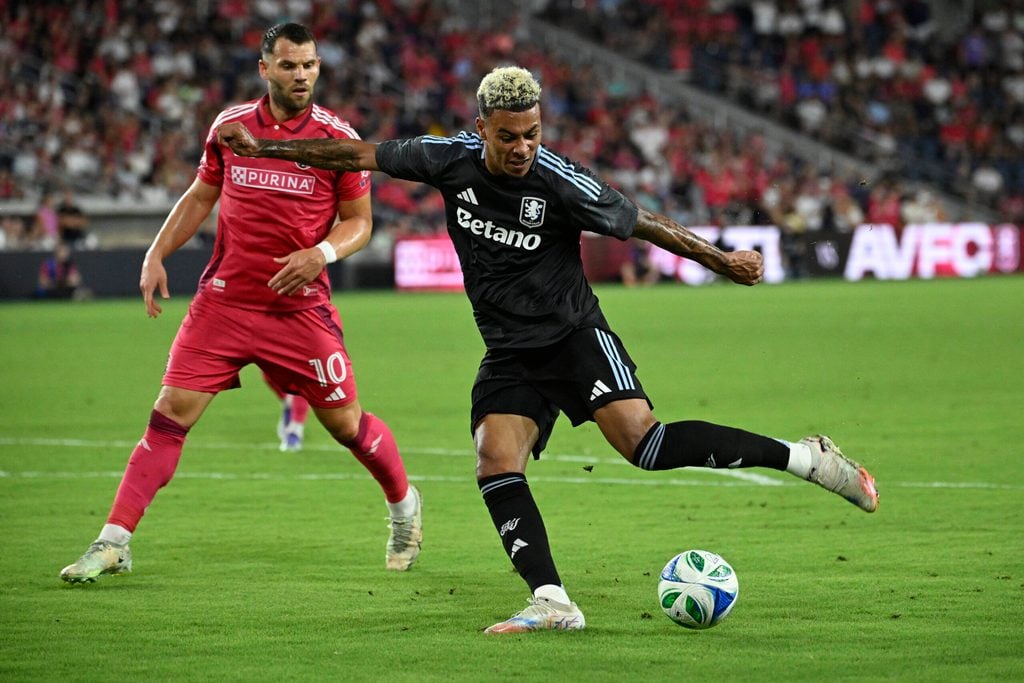 Jul 30, 2025; St. Louis, Missouri, USA; St. Louis City midfielder Eduard Lowen (10) pressures Aston Villa midfielder Morgan Rogers (27) as he takes a shot in the first half at Energizer Park. Mandatory Credit: Joe Puetz-Imagn Images