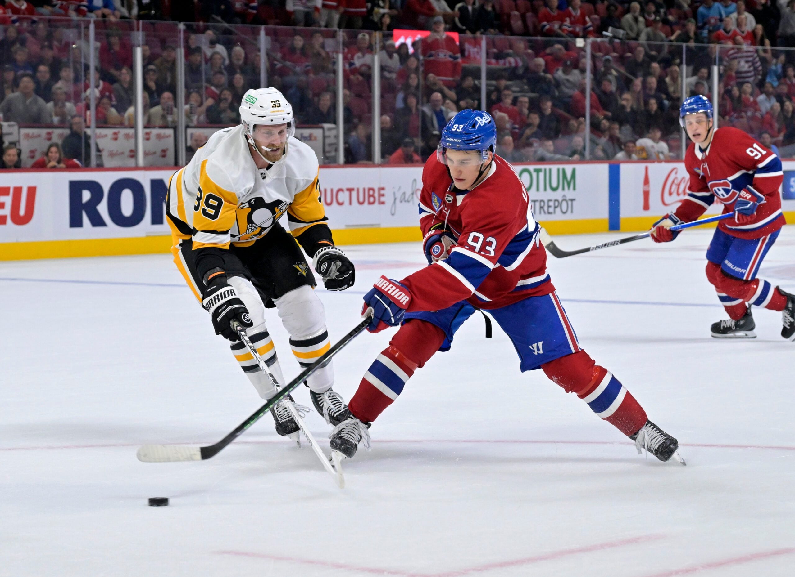 Sep 22, 2025; Montreal, Quebec, CAN; Montreal Canadiens forward Ivan Demidov (93) plays the puck and Pittsburgh Penguins forward Anthony Mantha (39) defends during the overtime period at the Bell Centre. Mandatory Credit: Eric Bolte-Imagn Images