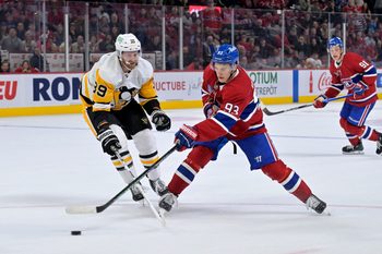 Sep 22, 2025; Montreal, Quebec, CAN; Montreal Canadiens forward Ivan Demidov (93) plays the puck and Pittsburgh Penguins forward Anthony Mantha (39) defends during the overtime period at the Bell Centre. Mandatory Credit: Eric Bolte-Imagn Images