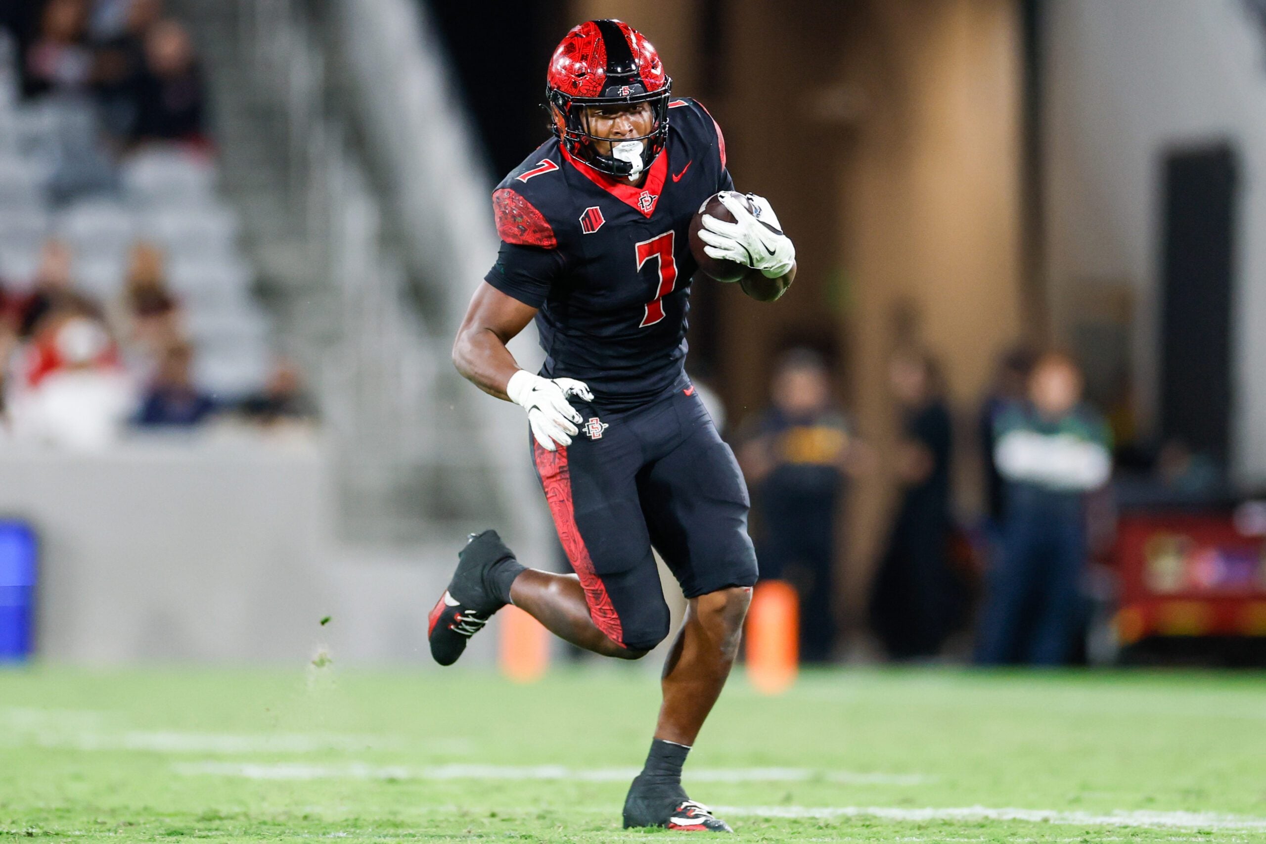 Oct 3, 2025; San Diego, California, USA; San Diego State Aztecs running back Lucky Sutton (7) runs the ball during the second half against the Colorado State Rams at Snapdragon Stadium. Mandatory Credit: David Frerker-Imagn Images