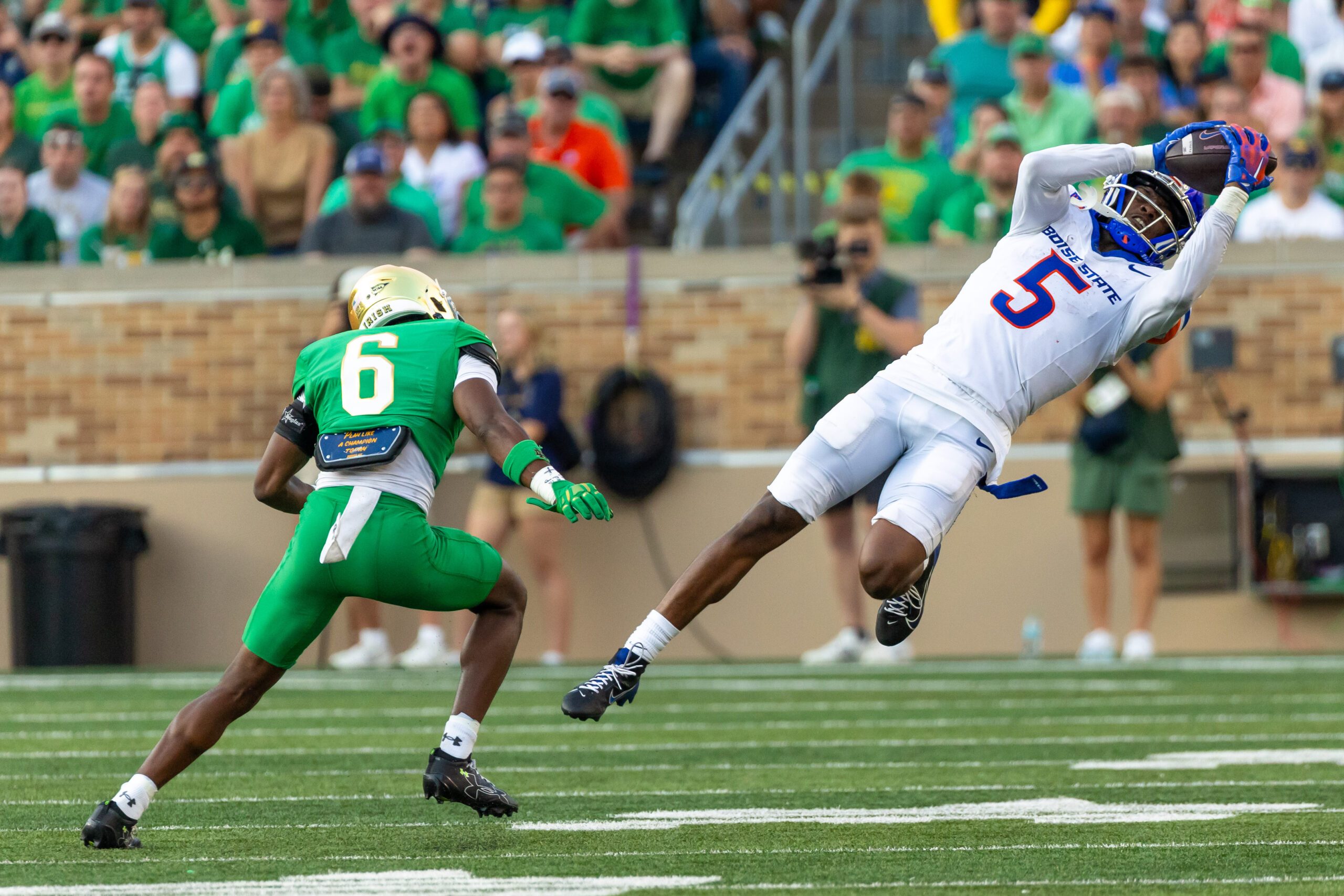 Oct 4, 2025; South Bend, Indiana, USA; Boise State Broncos wide receiver Chris Marshall (5) makes a catch that was called back due to offensive pass interference as Notre Dame Fighting Irish cornerback Christian Gray (6) defends during the second half at Notre Dame Stadium. Mandatory Credit: Michael Caterina-Imagn Images