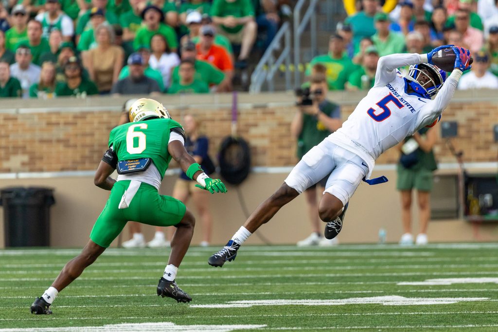 Oct 4, 2025; South Bend, Indiana, USA; Boise State Broncos wide receiver Chris Marshall (5) makes a catch that was called back due to offensive pass interference as Notre Dame Fighting Irish cornerback Christian Gray (6) defends during the second half at Notre Dame Stadium. Mandatory Credit: Michael Caterina-Imagn Images